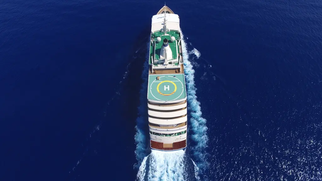 Fulk Al Salamah seen from directly above and astern, helideck in the foreground and her wake behind
