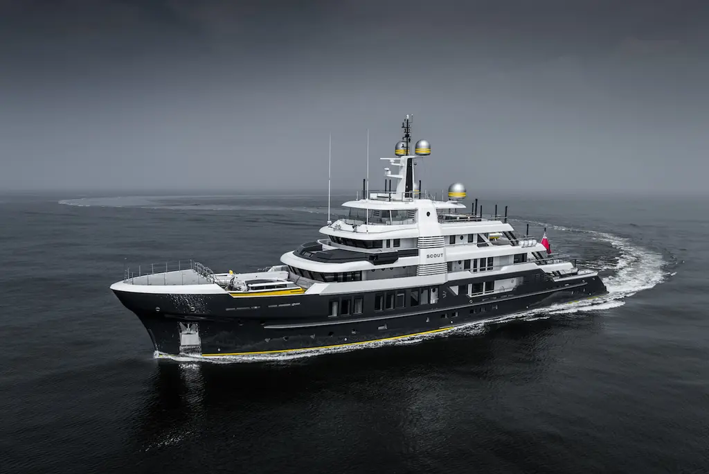 Scout from the port bow on a grey sea, the wake curving behind her