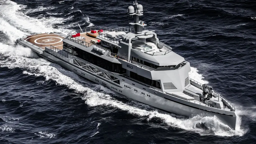 Bold under way at speed in dark water, seen from above off the starboard bow: a grey aluminium hull with a vertical bow, an angular superstructure and a helipad marked H on the aft deck