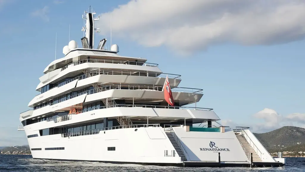 Renaissance stern with her name on the transom, red ensign and stairs down to the swim platform